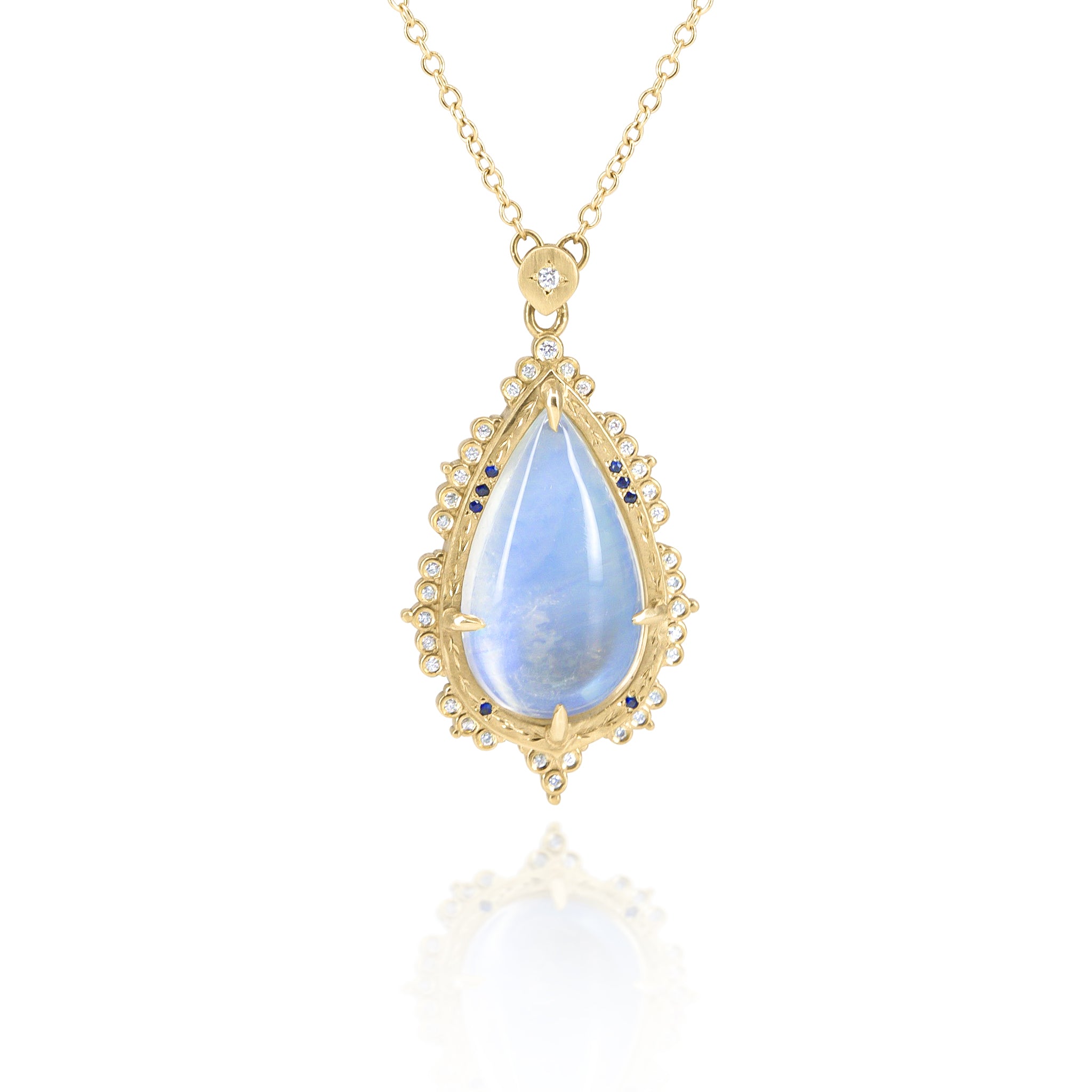 Gold necklace with a teardrop-shaped blue mooonstone pendant on a white background
